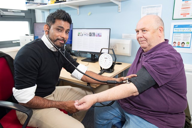 Doctor checking patients blood pressure